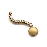 A circular gilt metal locket,