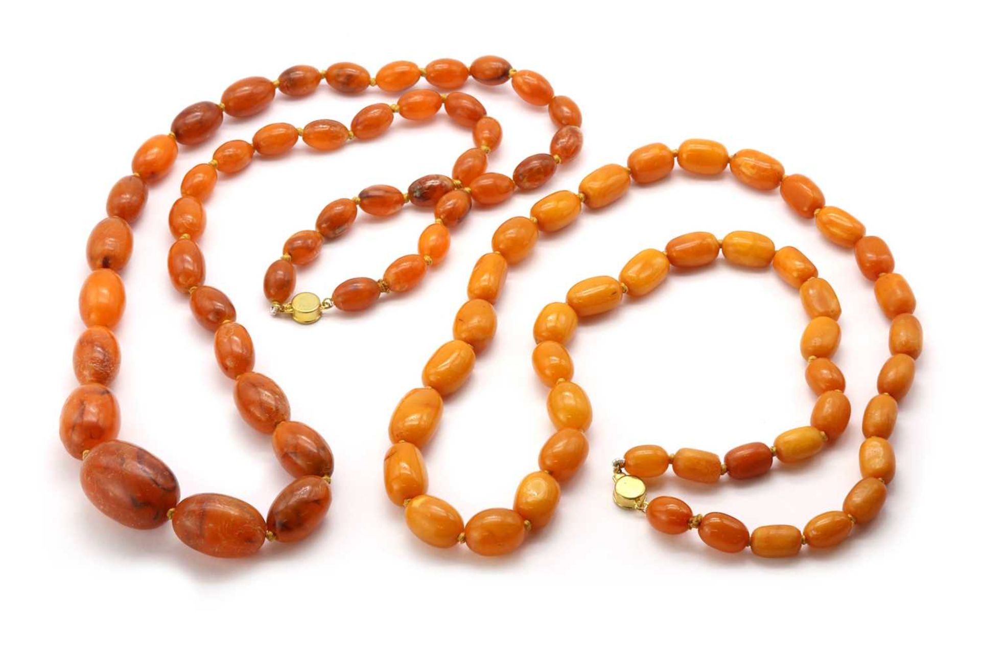 A single row graduated butter-scotch amber bead necklace,