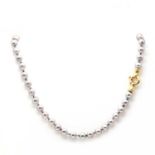 An 18ct gold single row semi baroque cultured pearl necklace,
