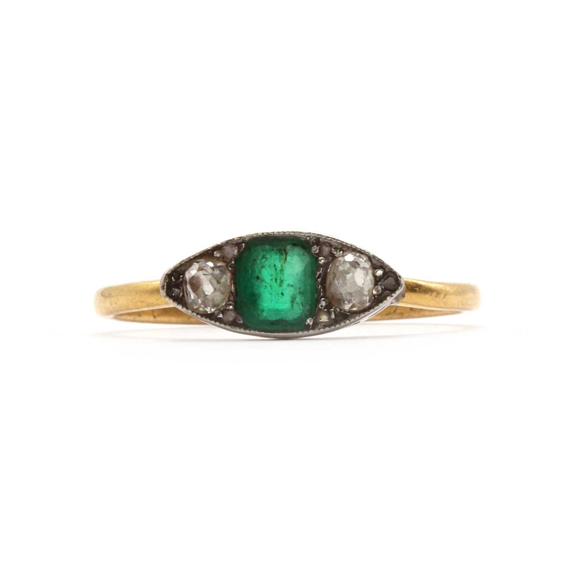 A three stone Emerald and diamond boat shaped ring,