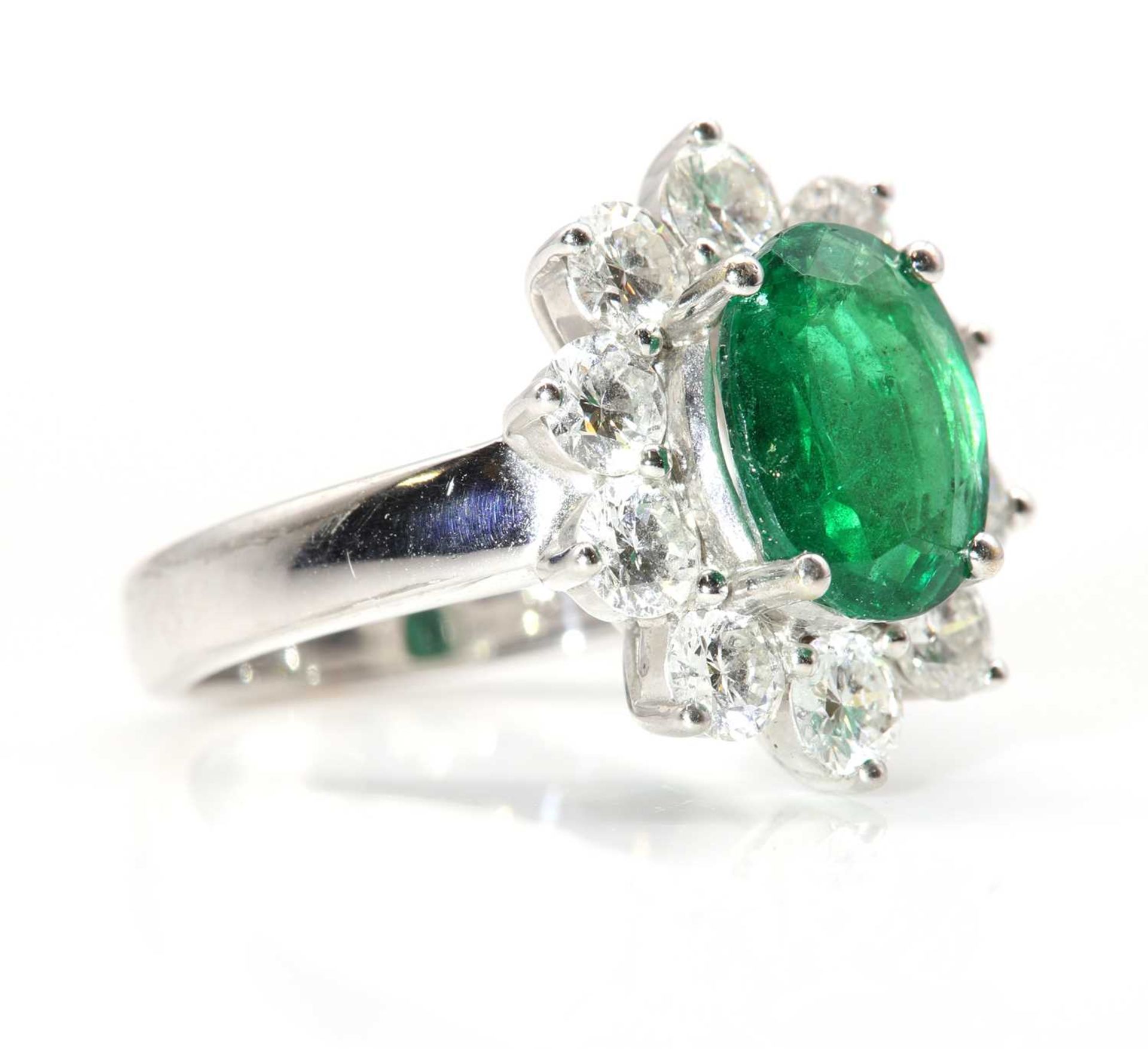 An 18ct white gold Zambian emerald and diamond oval cluster ring, - Image 3 of 7