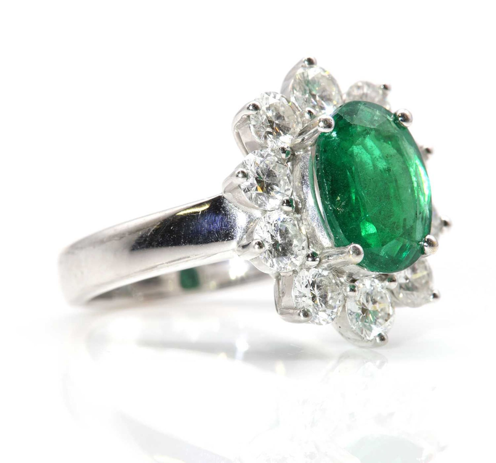 An 18ct white gold Zambian emerald and diamond oval cluster ring, - Image 4 of 7