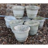 A set of eight small reconstituted stone garden urns,