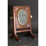 A Victorian brass-mounted oak shaving mirror,