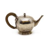 A small silver Queen Anne-style teapot,