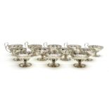 A set of twelve silver footed dessert dishes,