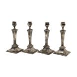 A set of four silver candlesticks