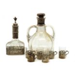 A Dutch silver mounted decanter and six silver cup holders,