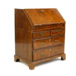 A Georgian walnut and feather banded bureau