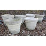 A set of six large reconstituted stone garden urns