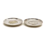 A pair of silver coin dishes,
