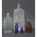 A collection of five poison bottles,