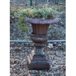 A glazed stoneware garden urn and stand