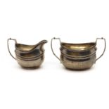 A silver cream jug and twin-handled sugar bowl