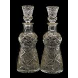 A pair of cut glass thistle shaped decanters and stoppers,