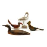 A group of four wooden figures of ducks