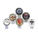 A collection of car badges,