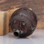 A carved 'bugbear' coconut flask,