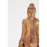 A lacquered and giltwood standing Buddha,
