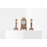 A small pink marble clock garniture,