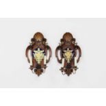 A pair of walnut, parcel-gilt and verre églomisé wall sconces,