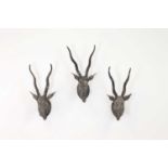 A set of three carved polychrome antelope,