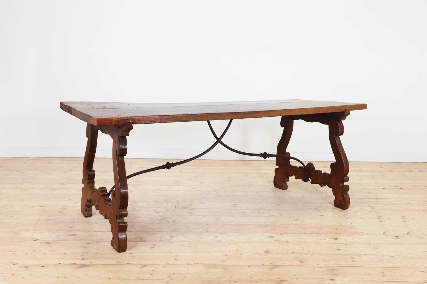 A walnut and wrought iron table,