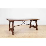 A walnut and wrought iron table,