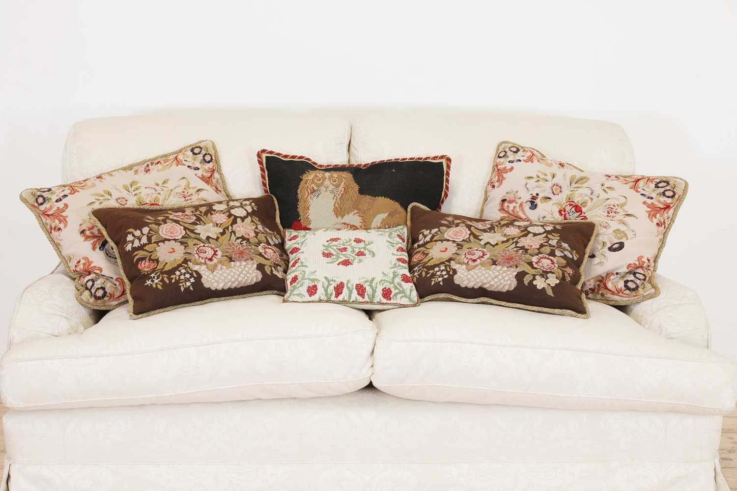 A group of six needlepoint cushions,