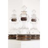 A set of three glass scrooge decanters,