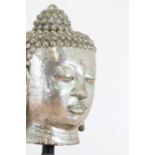 A large cast metal head of Buddha,