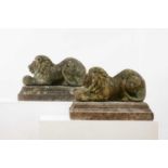 A pair of reconstituted stone recumbent lions,