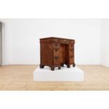 A George I walnut and feather-banded kneehole desk,