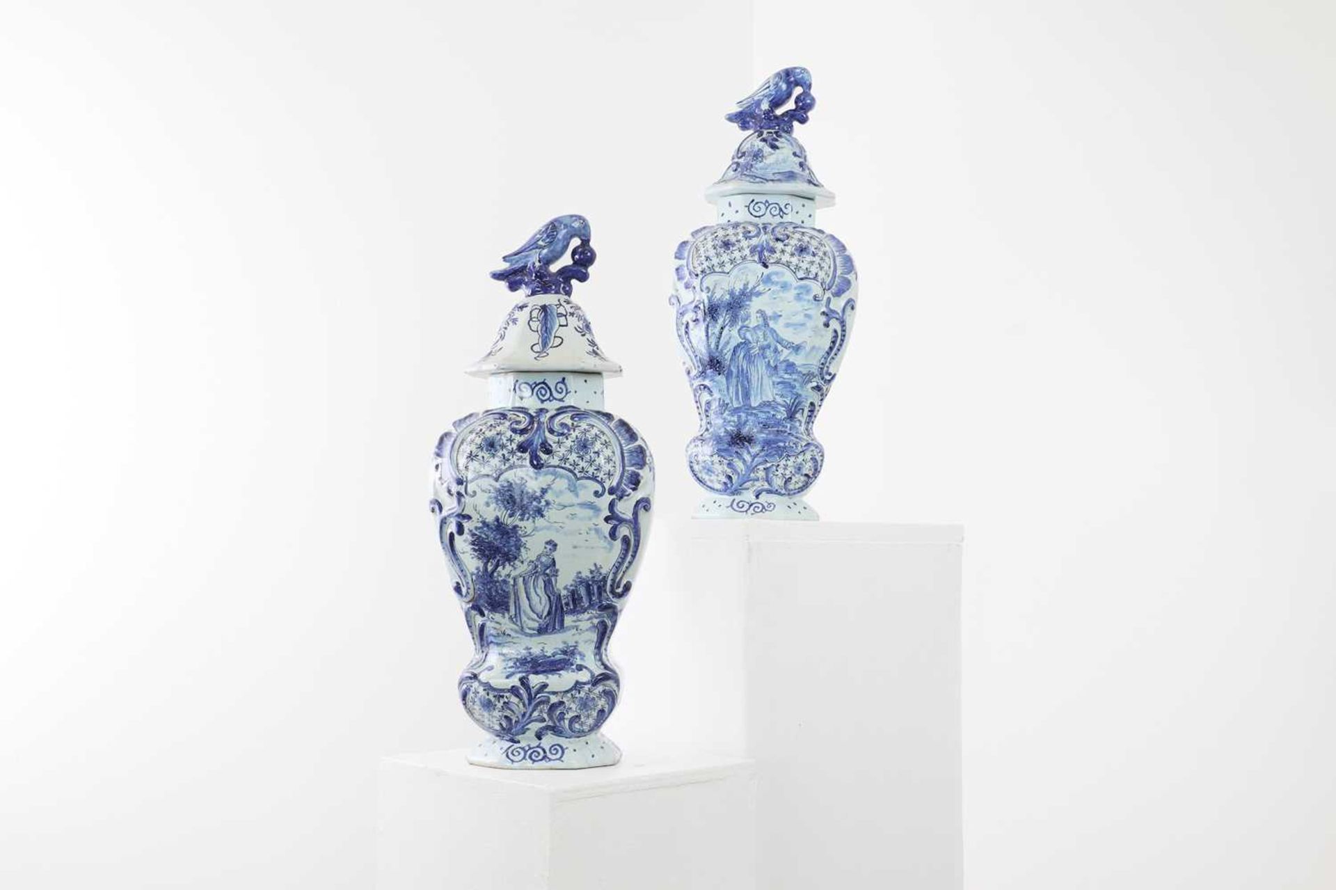 A pair of tin-glazed earthenware vases and covers,