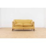 A small upholstered sofa by Howard & Sons,