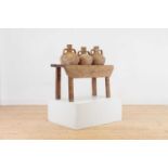 A pine pot stand containing three clay amphora vases,