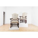A pair of large walnut open armchairs,