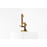 A lacquered brass binocular microscope,