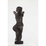 A carved pine figure of a putto,