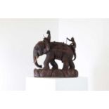 A carved teak figure of an elephant,