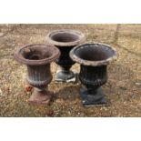 A group of three Victorian cast iron garden Campana urns