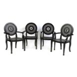 A set of four ebonised armchairs,