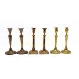 Two pairs of Georgian brass candlesticks,