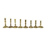 Eight Georgian brass candlesticks,