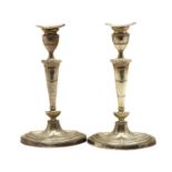 A pair of George V silver candlesticks,