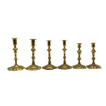 Two pairs of Georgian brass candlesticks,