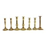Three pairs of brass candlesticks,
