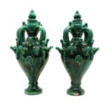 A pair of green glazed stoneware urns,