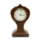 An Edwardian strung mahogany balloon shaped mantel timepiece