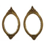 A pair of gilt composition wall mirrors,